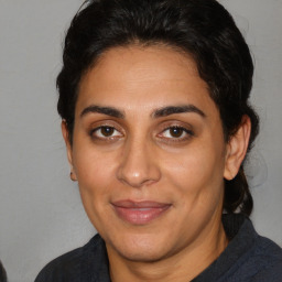 Joyful latino adult female with short  brown hair and brown eyes