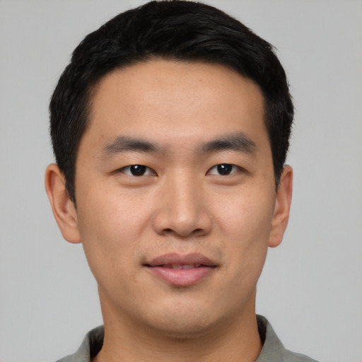 Joyful asian young-adult male with short  black hair and brown eyes