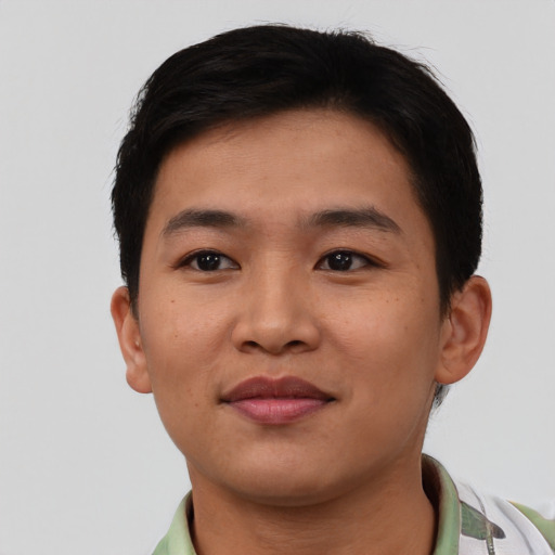 Joyful asian young-adult male with short  brown hair and brown eyes
