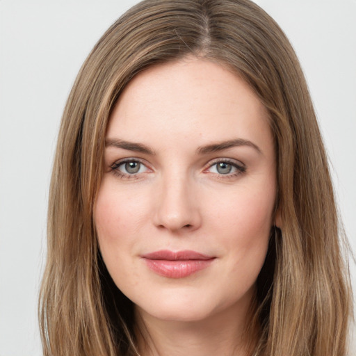 Joyful white young-adult female with long  brown hair and green eyes