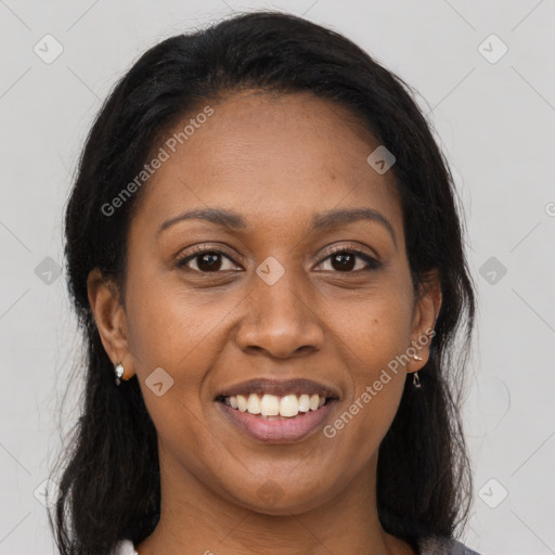 Joyful black young-adult female with long  brown hair and brown eyes