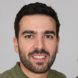 Joyful white young-adult male with short  black hair and brown eyes