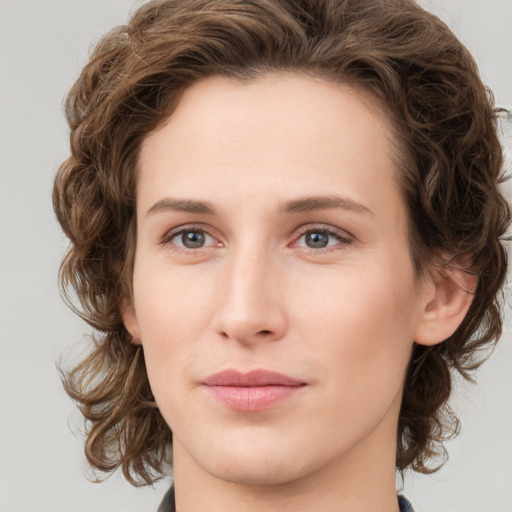 Joyful white young-adult female with medium  brown hair and green eyes