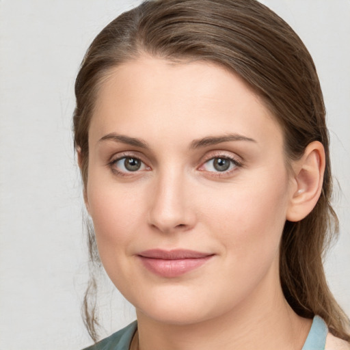 Joyful white young-adult female with medium  brown hair and grey eyes