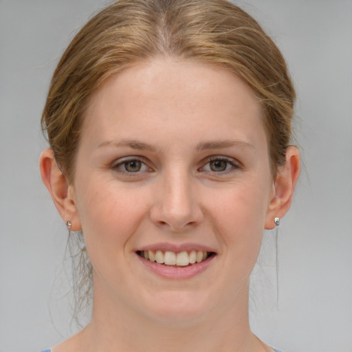 Joyful white young-adult female with medium  brown hair and blue eyes