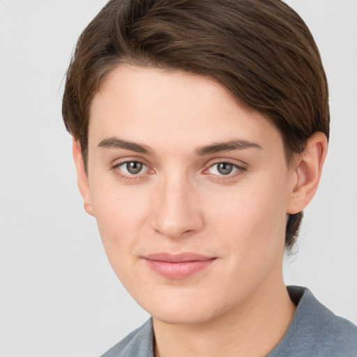 Joyful white young-adult female with short  brown hair and grey eyes