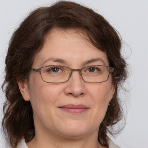 Joyful white adult female with medium  brown hair and grey eyes