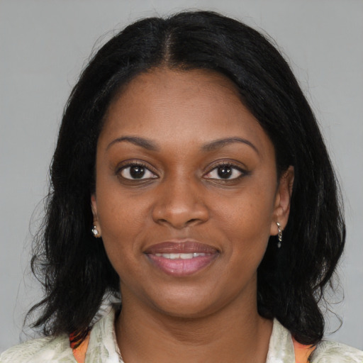 Joyful black young-adult female with medium  brown hair and brown eyes
