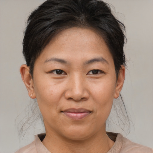 Joyful asian adult female with short  brown hair and brown eyes
