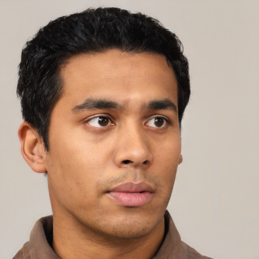 Neutral latino young-adult male with short  black hair and brown eyes