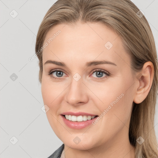 Joyful white young-adult female with long  brown hair and grey eyes