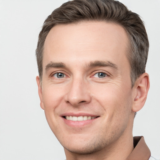 Joyful white young-adult male with short  brown hair and brown eyes