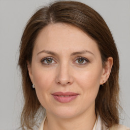 Joyful white adult female with medium  brown hair and grey eyes