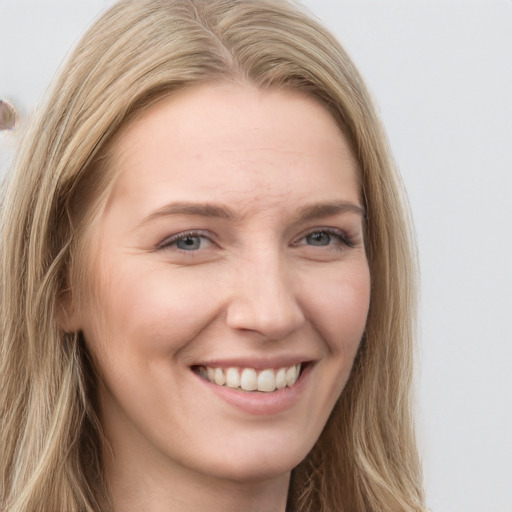 Joyful white young-adult female with long  brown hair and grey eyes