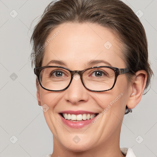 Joyful white adult female with medium  brown hair and brown eyes