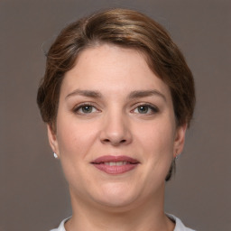 Joyful white young-adult female with short  brown hair and grey eyes