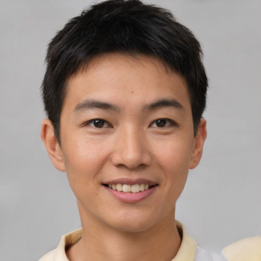 Joyful asian young-adult male with short  brown hair and brown eyes