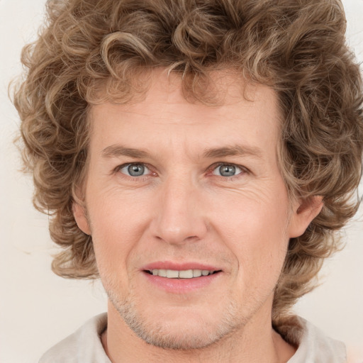 Joyful white young-adult male with medium  brown hair and brown eyes