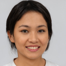 Joyful asian young-adult female with medium  brown hair and brown eyes