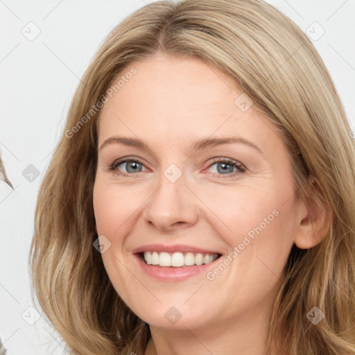 Joyful white adult female with long  brown hair and brown eyes