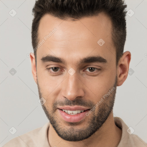 Joyful white young-adult male with short  brown hair and brown eyes