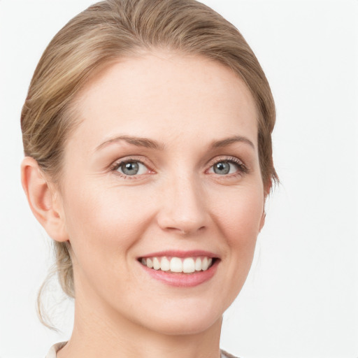 Joyful white young-adult female with medium  brown hair and blue eyes