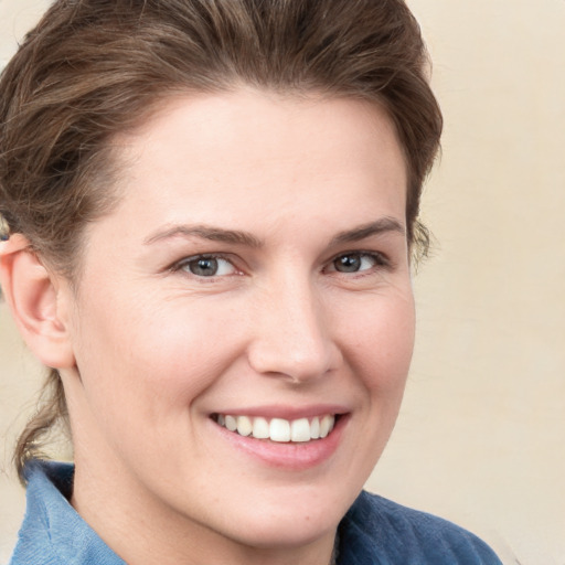 Joyful white young-adult female with medium  brown hair and blue eyes