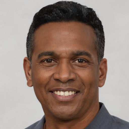 Joyful latino adult male with short  black hair and brown eyes