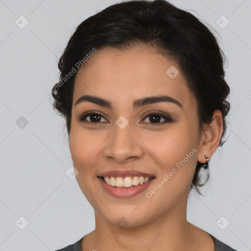 Joyful latino young-adult female with long  brown hair and brown eyes