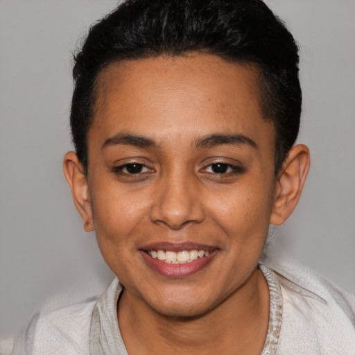 Joyful latino young-adult female with short  brown hair and brown eyes