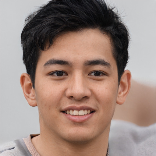 Joyful asian young-adult male with short  brown hair and brown eyes