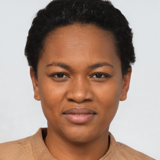 Joyful black young-adult female with short  black hair and brown eyes