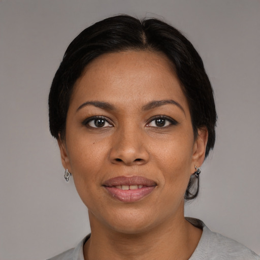 Joyful black young-adult female with medium  brown hair and brown eyes