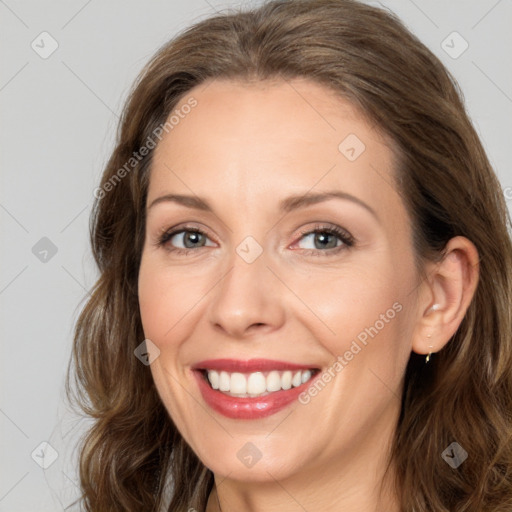 Joyful white adult female with long  brown hair and brown eyes