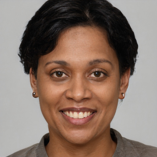 Joyful latino adult female with short  brown hair and brown eyes