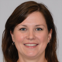 Joyful white adult female with medium  brown hair and grey eyes