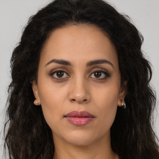 Joyful latino young-adult female with long  brown hair and brown eyes