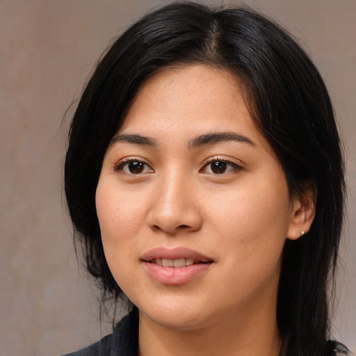 Joyful white young-adult female with medium  black hair and brown eyes