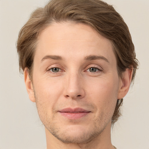 Joyful white adult male with short  brown hair and grey eyes