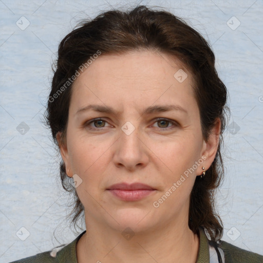 Joyful white adult female with medium  brown hair and grey eyes