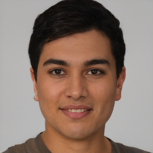 Joyful latino young-adult male with short  black hair and brown eyes