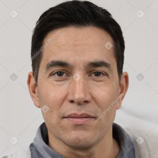 Joyful white adult male with short  black hair and brown eyes