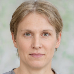 Joyful white adult female with medium  brown hair and grey eyes