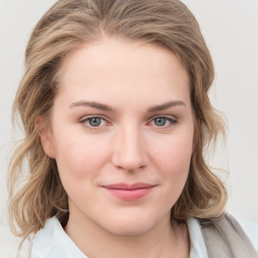 Joyful white young-adult female with medium  brown hair and blue eyes