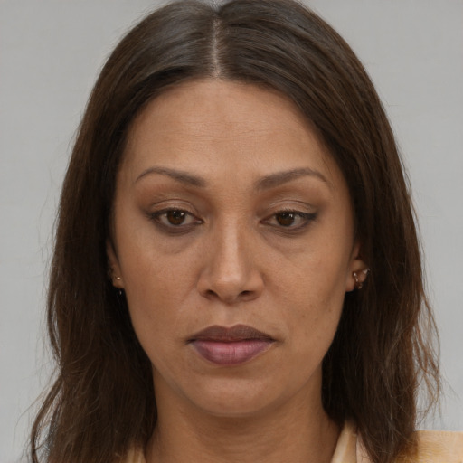 Joyful white adult female with long  brown hair and brown eyes