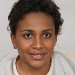 Joyful black young-adult female with short  brown hair and brown eyes