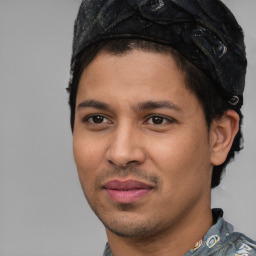 Joyful latino young-adult male with short  black hair and brown eyes