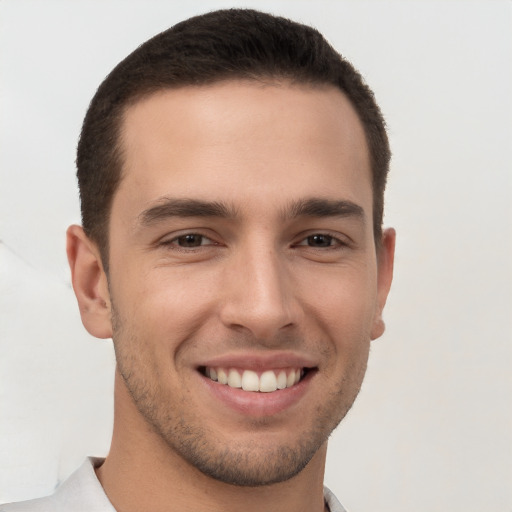 Joyful white young-adult male with short  brown hair and brown eyes