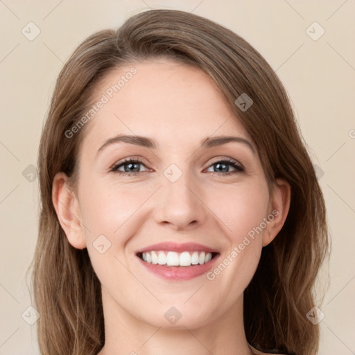 Joyful white young-adult female with long  brown hair and green eyes