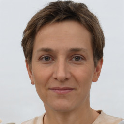 Joyful white adult female with short  brown hair and brown eyes